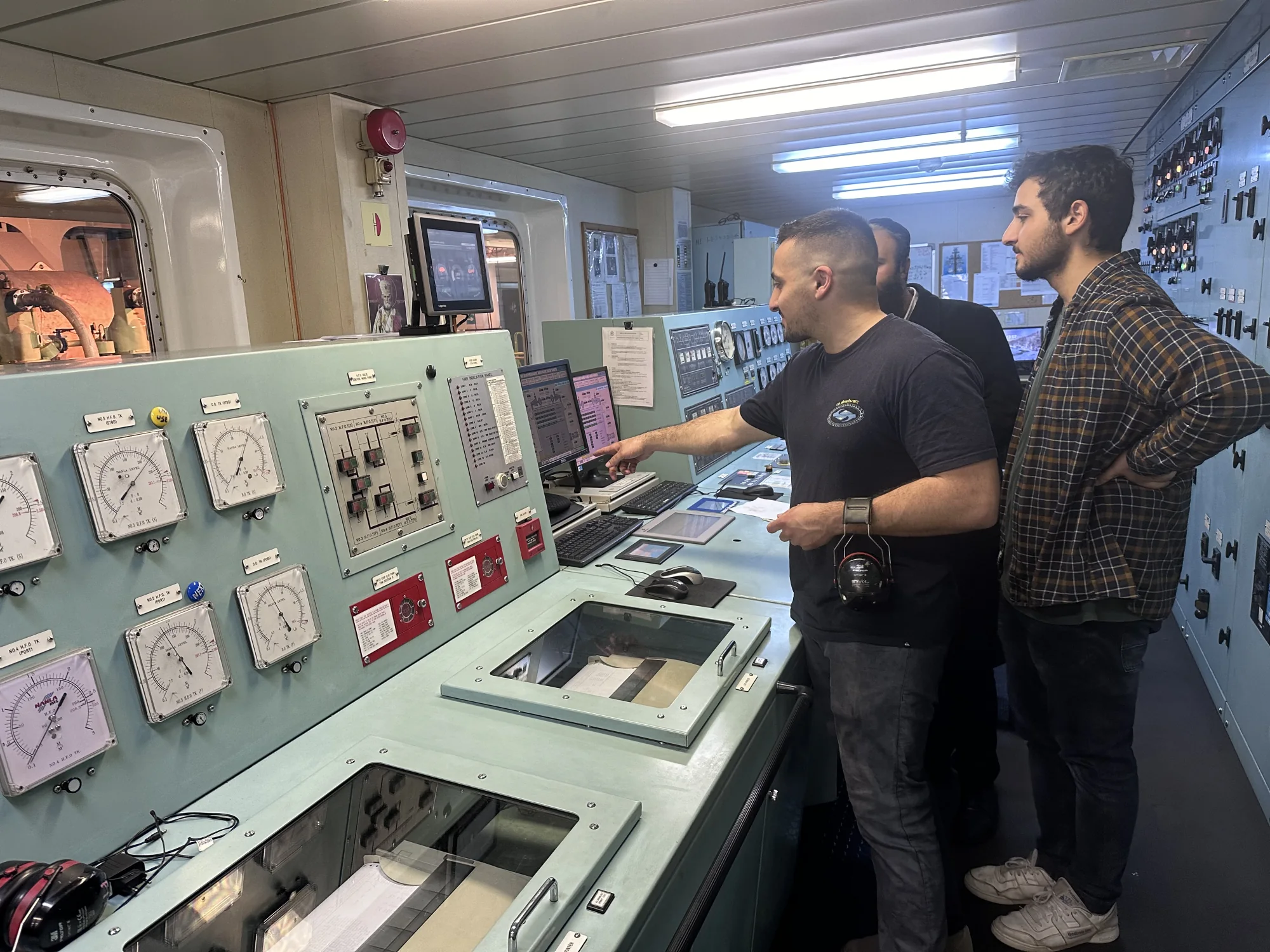 Newlight team reviewing vessel systems in a ship control room